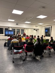 Attendees watching a demo at an Experience Cafe evening