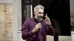 A speaker taking the mic at an Experience Cafe meetup