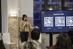 A speaker presenting at an Experience Cafe evening in Berlin